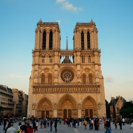 PARIS, FRANCE - MAY 13: Notre Dame de Paris cathedral with tourists at sunset on May 13, 2015 in Paris. With the population of 2M, Paris is the capital and most-populous city of France